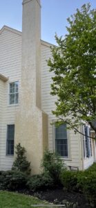 Soft wash stucco chimney after