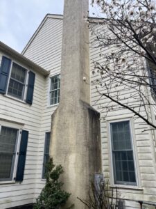 Soft wash stucco chimney before